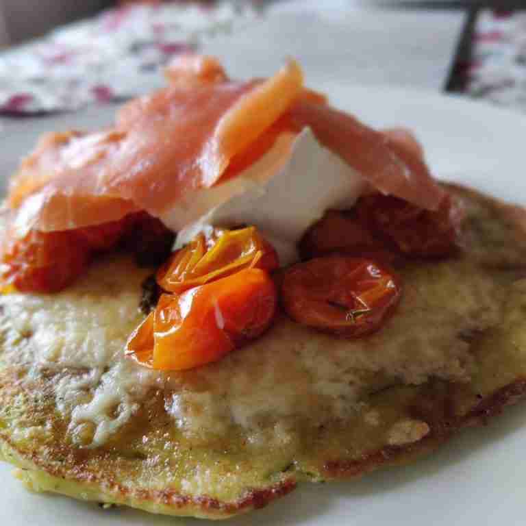 image of a pancake topped with roasted tomatoes, crème fraiche and salmon you can learn how to make this at cookery school Gourmandises Academie in Cambridge UK