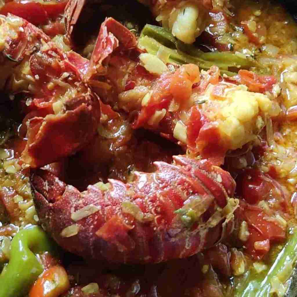 picture with lobster tails in a tomato sauce, you can learn how to make this at cookery school Gourmandises Academie in Cottenham, Cambridge