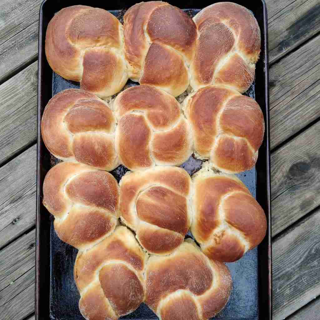image with a selection of 9 braided buns in a tray, you can learn how to make them with cookery school gourmandises academie, cambridge
