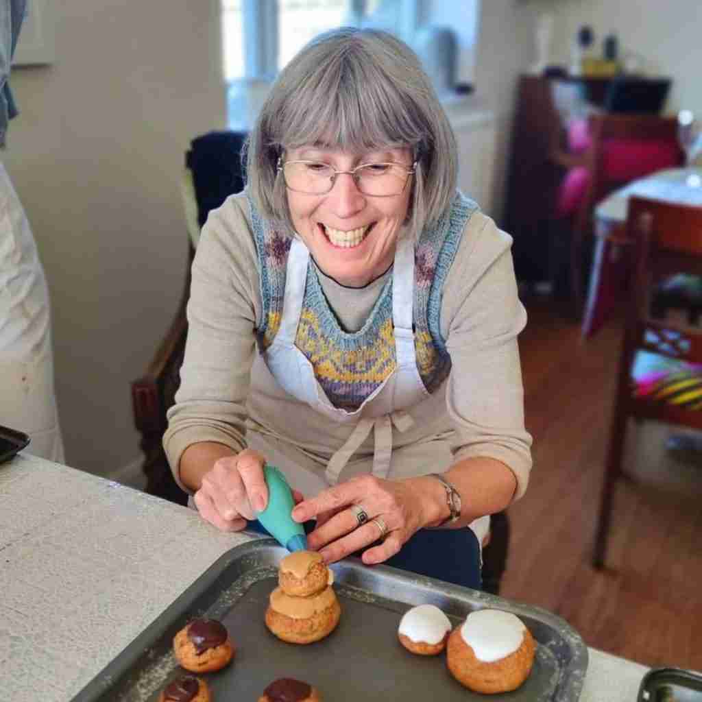 Picture of a lady piping a religieuse, you can learn how to make religieuses at cookery school Gourmandises Academie in Cottenham