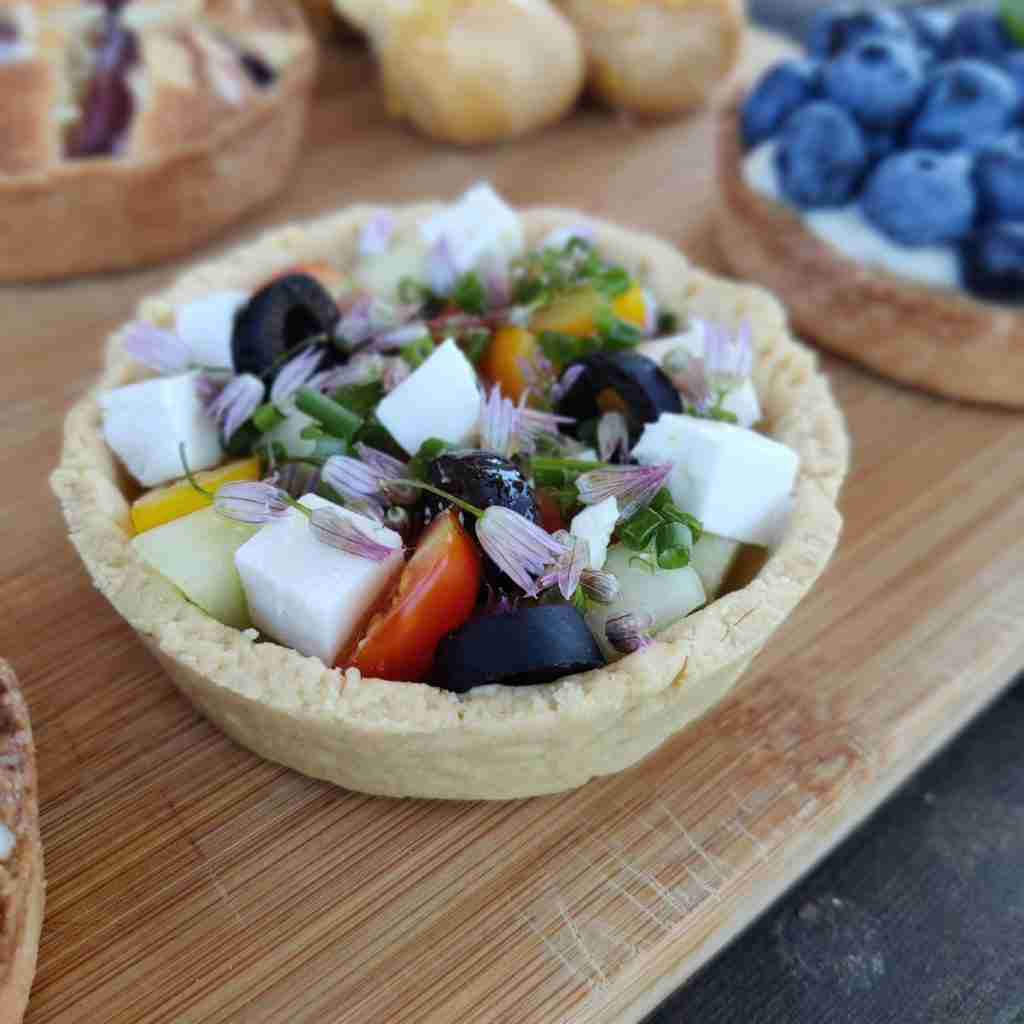 image of a croustade filled with olives, fresh tomatoes, herbs and feta cheese