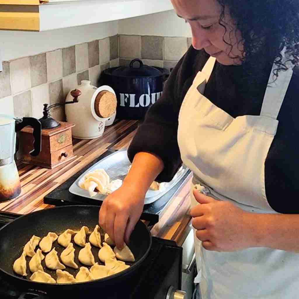 image of Corinne Payet preparing Gyoza, she is the cooking instructor and owner of cookery school gourmandises academie, Cambridge